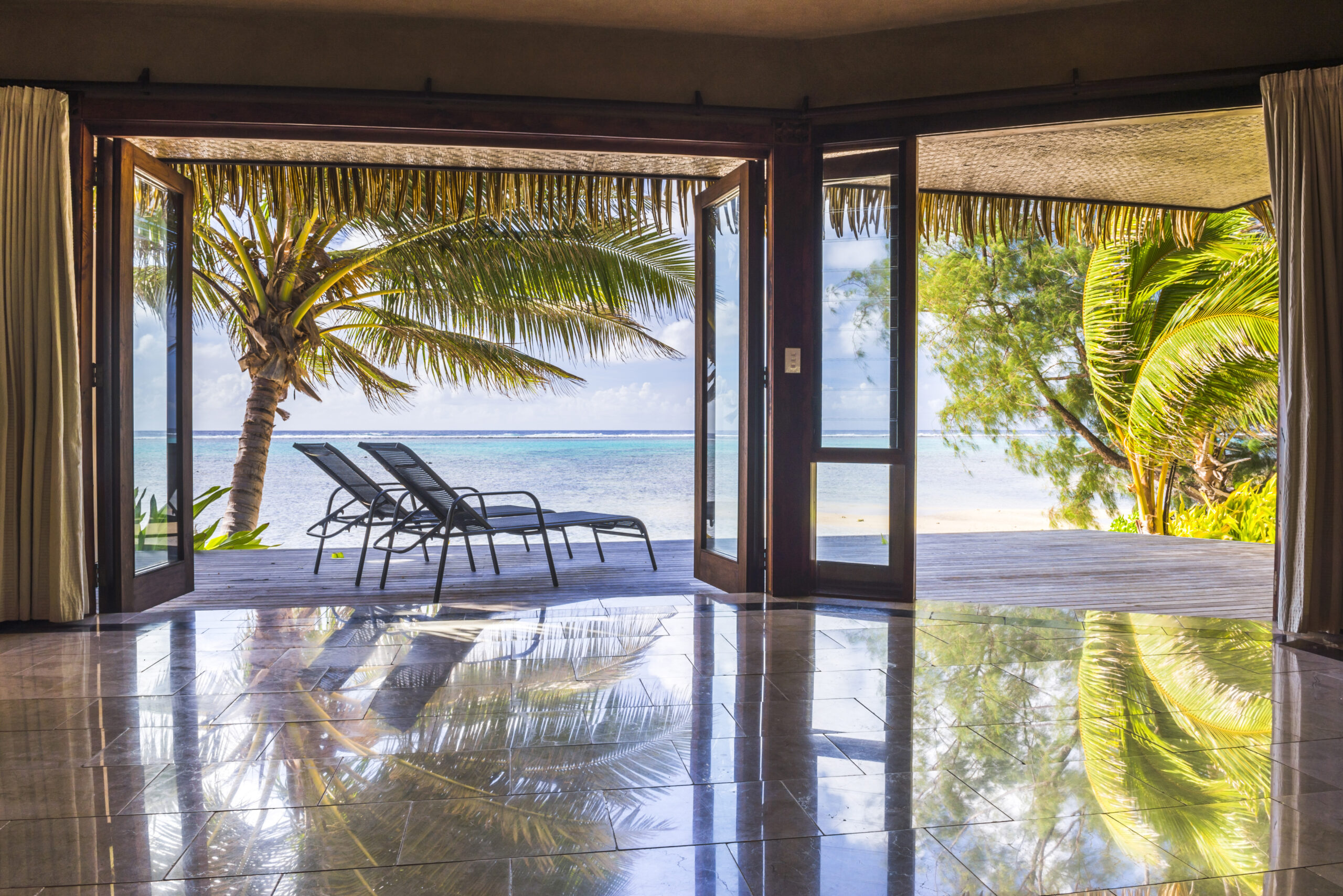 Luxury Villa accommodation with sea views of the tropical Pacific ocean and palm trees, Muri, Raroto